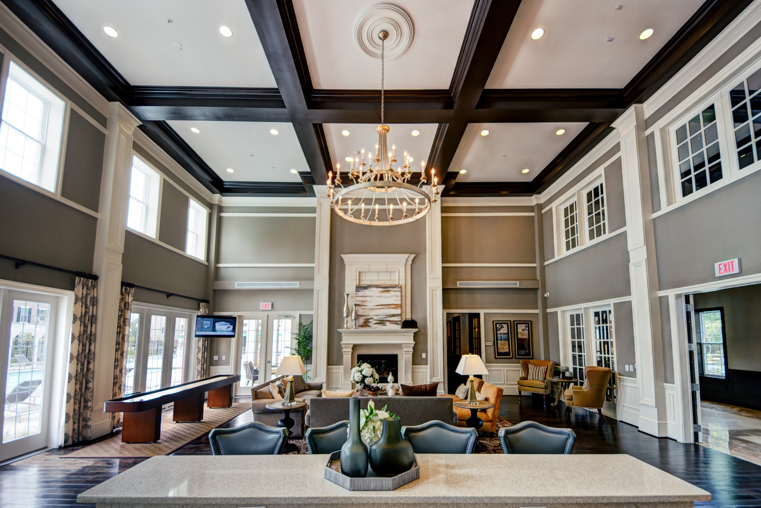 a large lobby with a fireplace and a chandelier