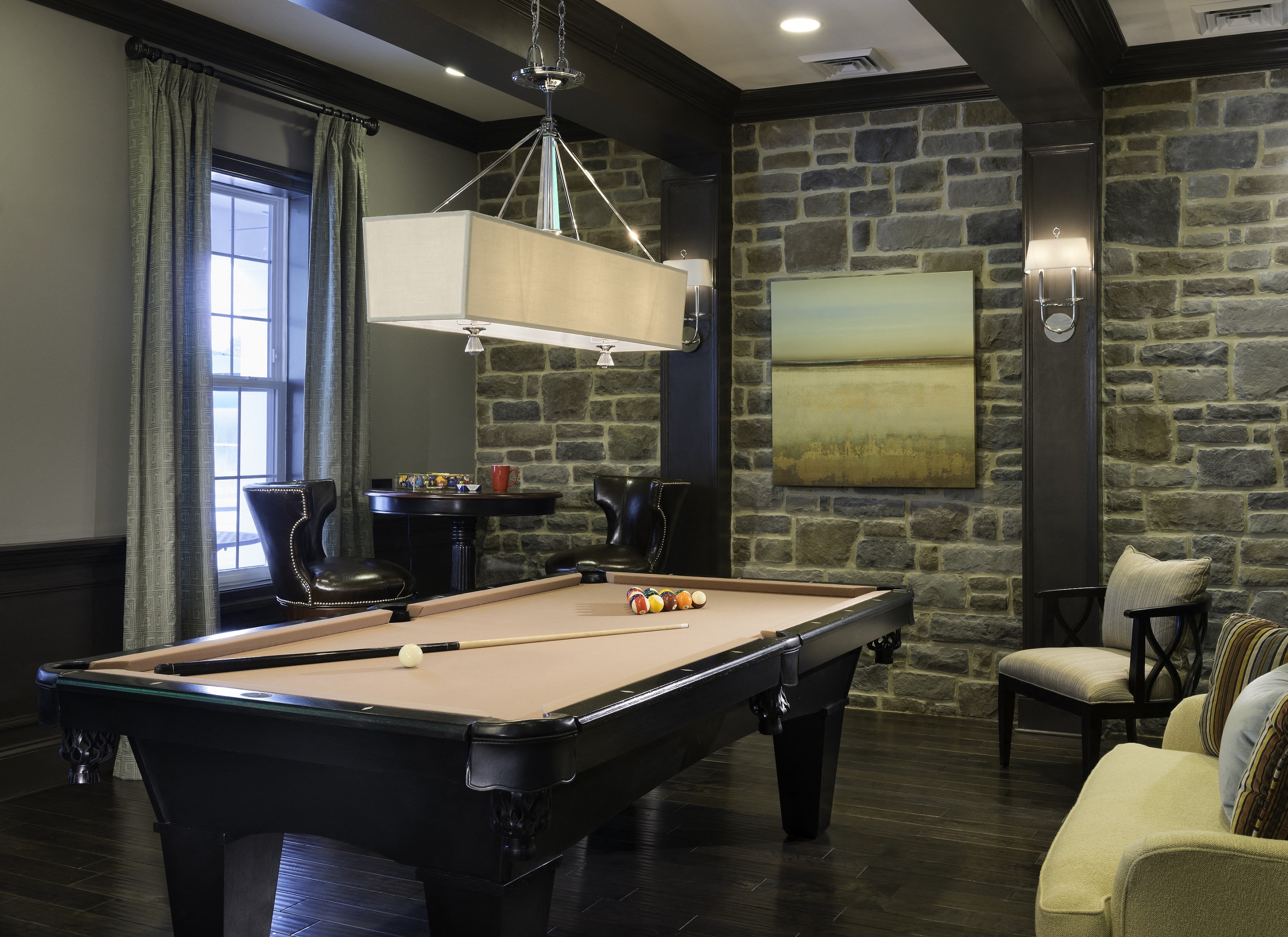 a game room with a pool table and a chandelier