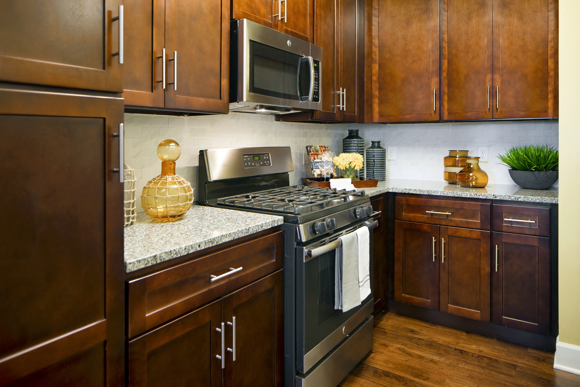 a kitchen with stainless steel appliances and wooden cabinets