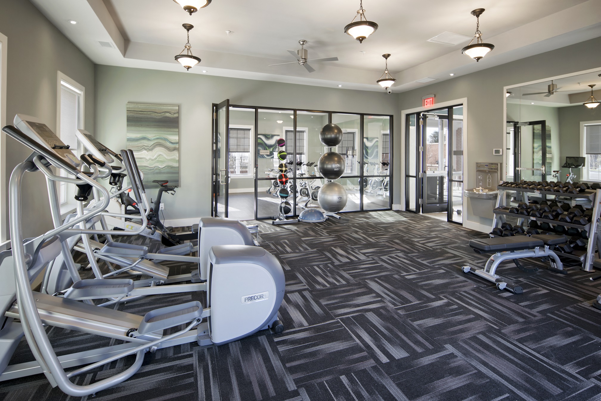 a gym with weights and cardio equipment at the monarch apartments in midtown