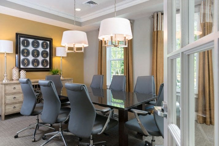a conference room with a glass table and chairs