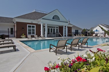 Pool and chairs behind clubhouse