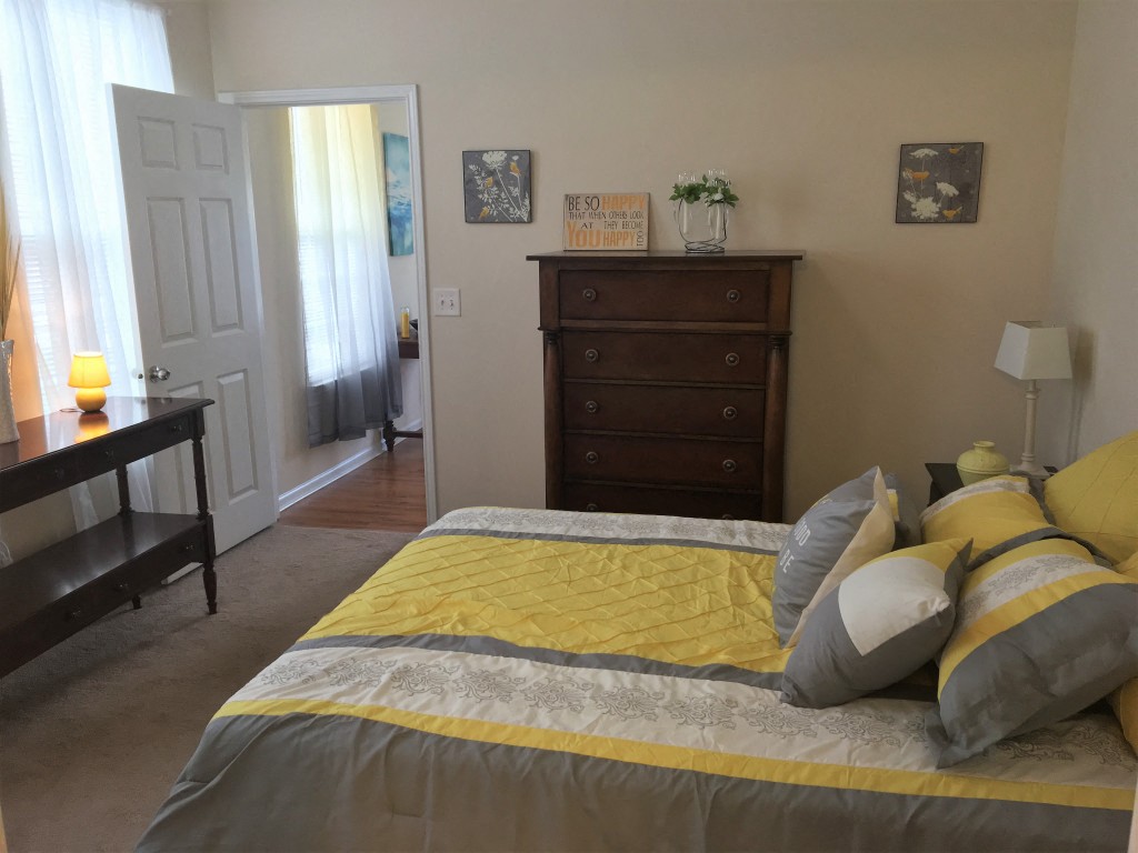 a bedroom with a bed and a dresser in it