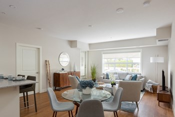 The Conservatory open concept suite with view of living room from dining area in Kelowna, BC - Photo Gallery 2