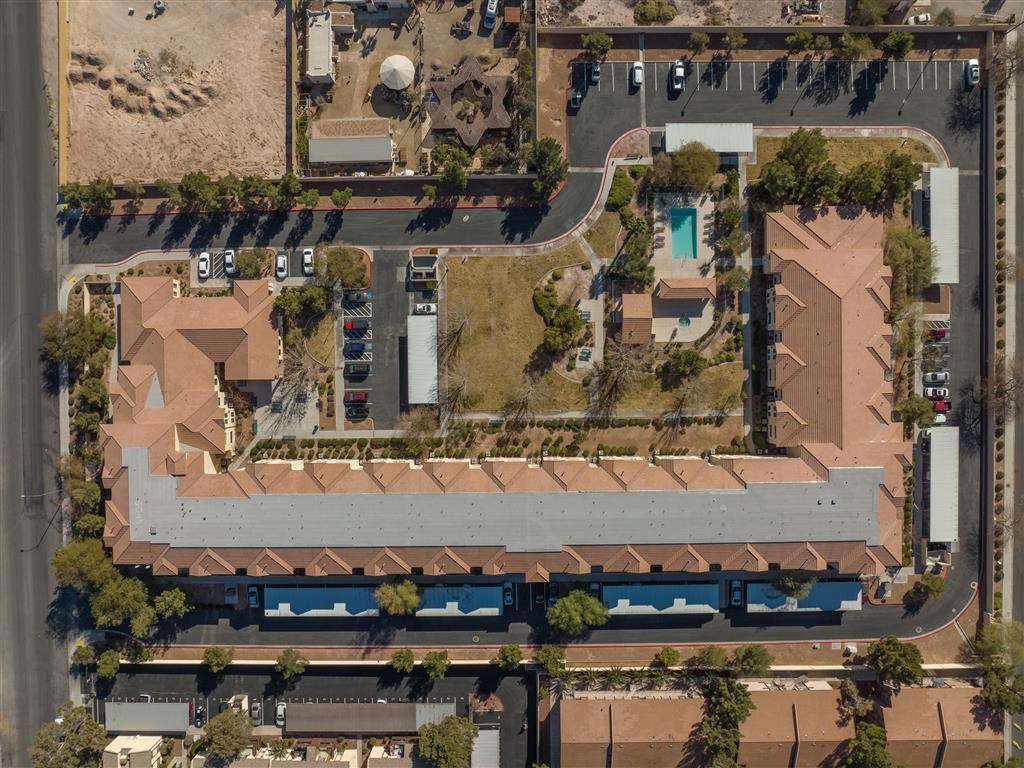 an aerial view of a city with a parking lot and