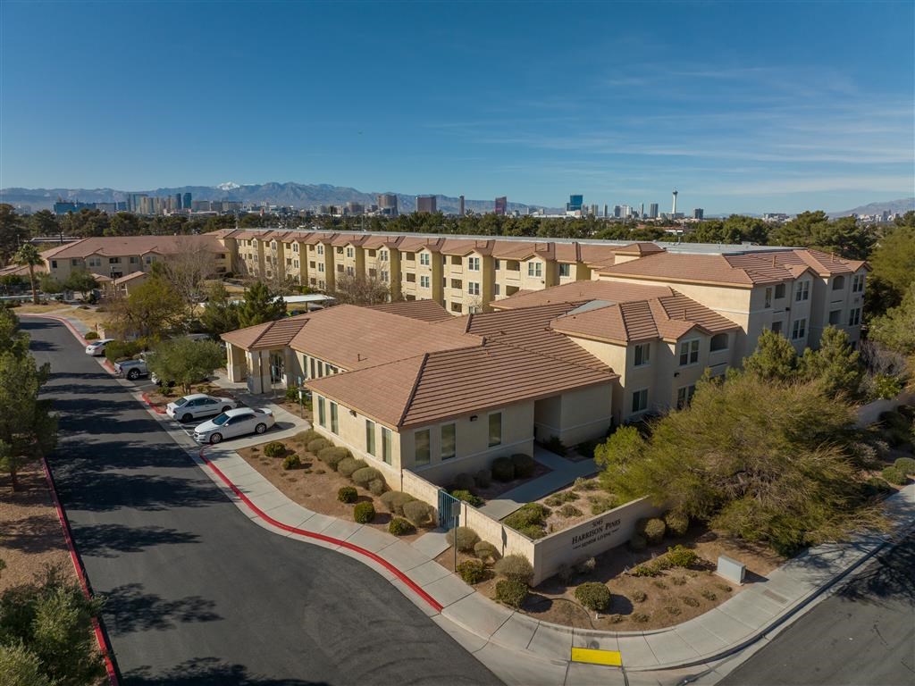 an aerial view of an apartment complex with cars parked in front of it