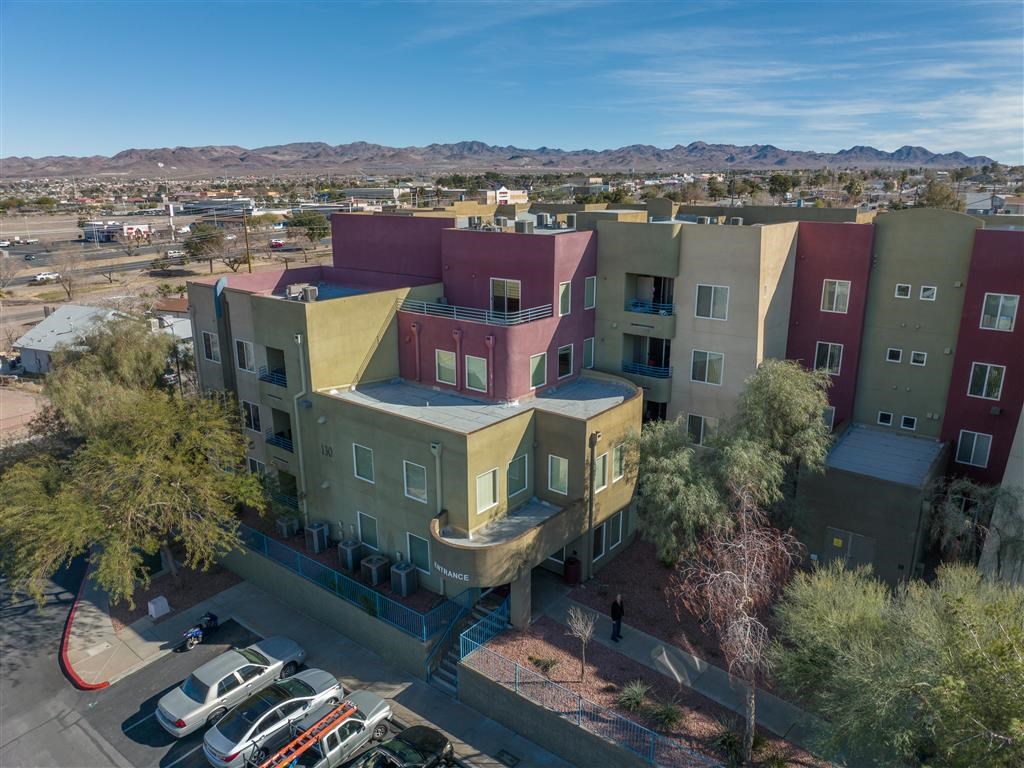a view of the buildings from above and a parking lot