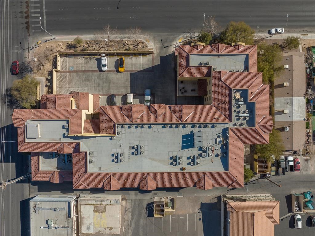an aerial view of a large house with a red roof
