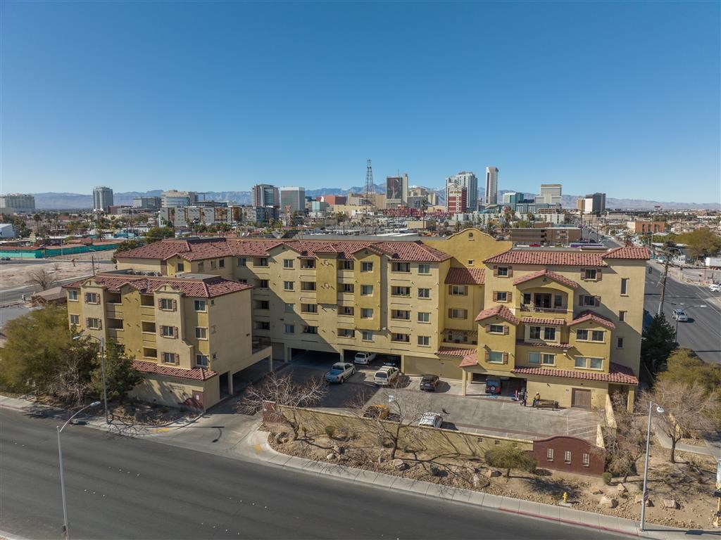 an aerial view of a building with a city in the background
