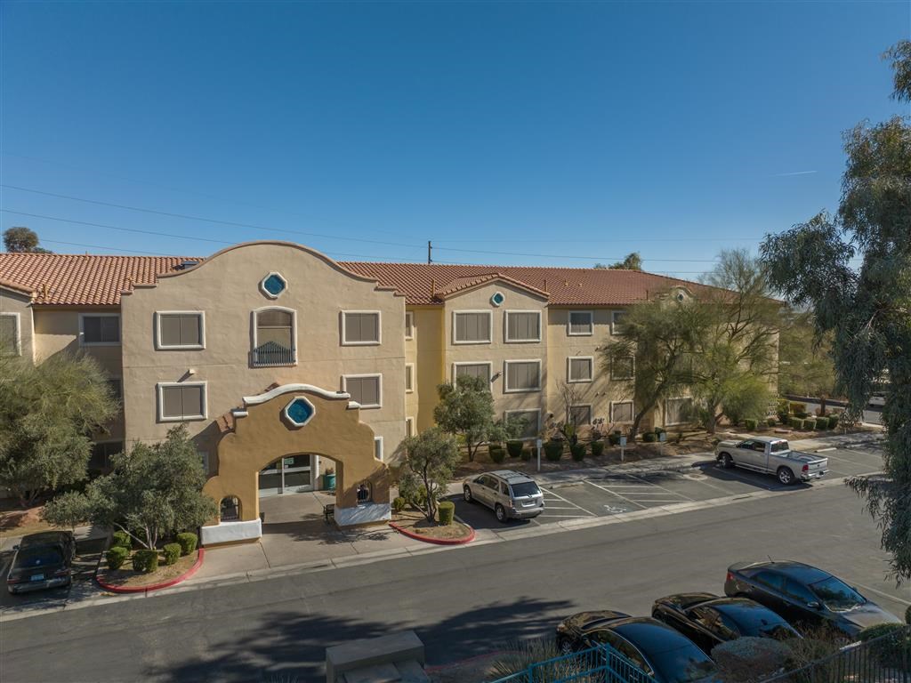 an aerial view of an apartment building with a parking lot
