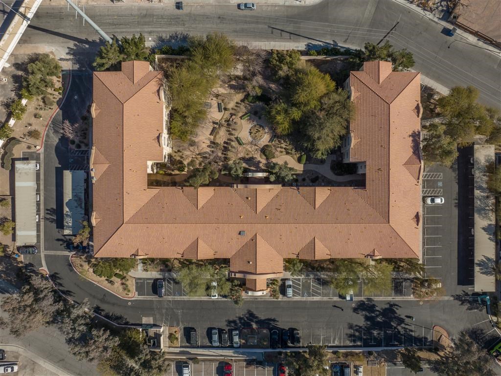 an aerial view of a building with a roof and a street