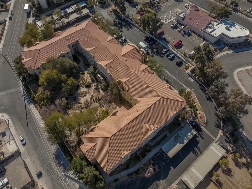 an aerial view of a building with a brown roof