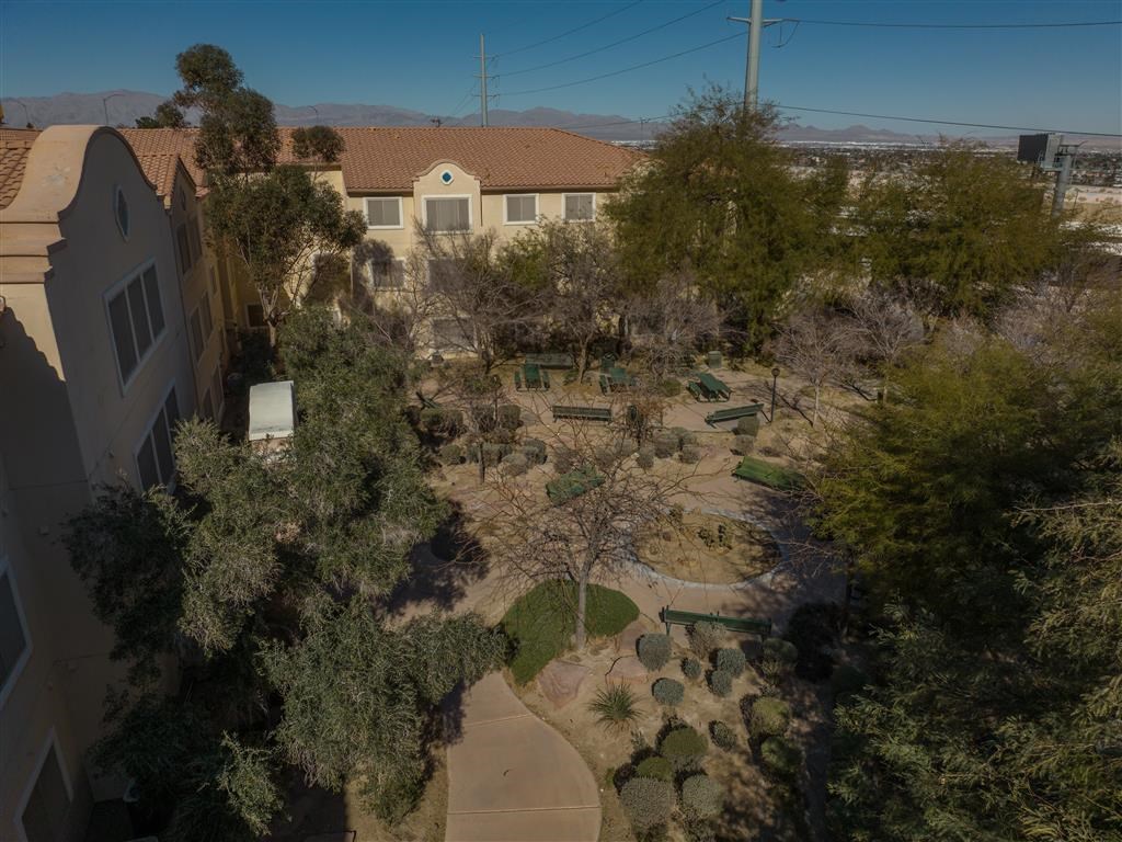 a birds eye view of a backyard with trees and a house
