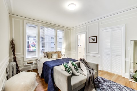 A bedroom with a bed and a couch.