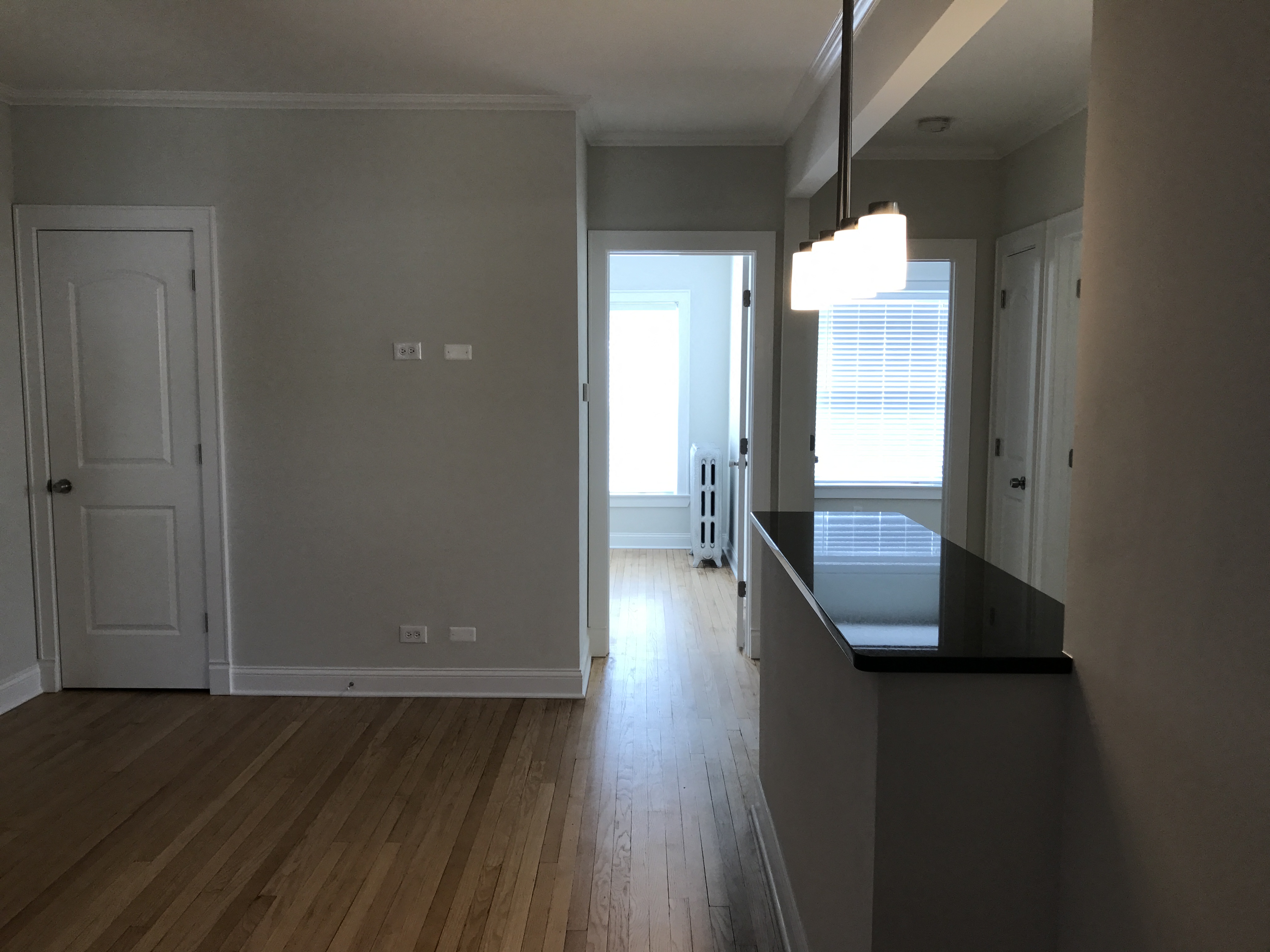 a view from the kitchen into the living room and dining room