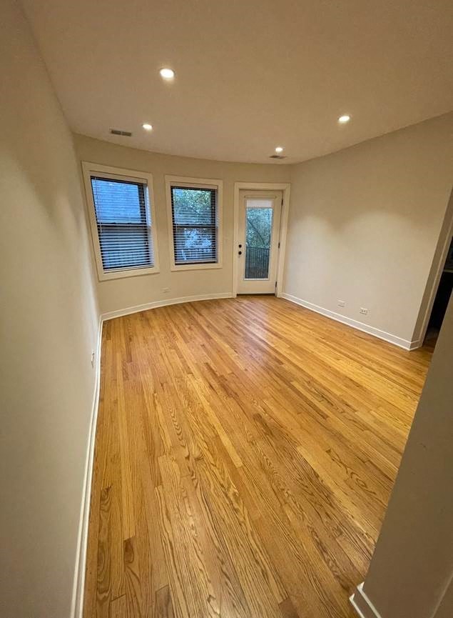 a empty living room with a hard wood floor