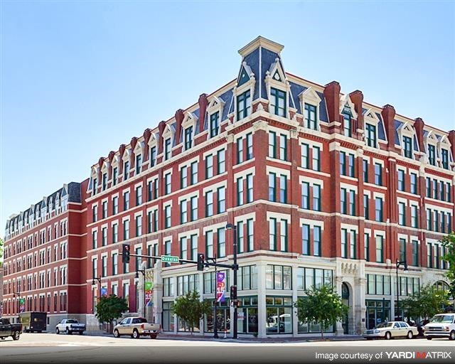 a large red brick building on the corner of a street