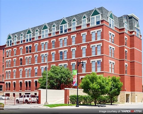 a large red brick building on the side of a street