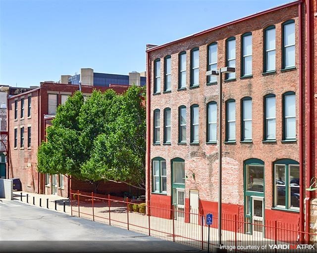 a row of brick buildings on the side of a street