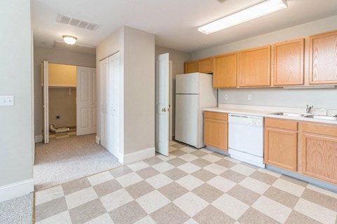 a kitchen with a checkered floor and a white refrigerator