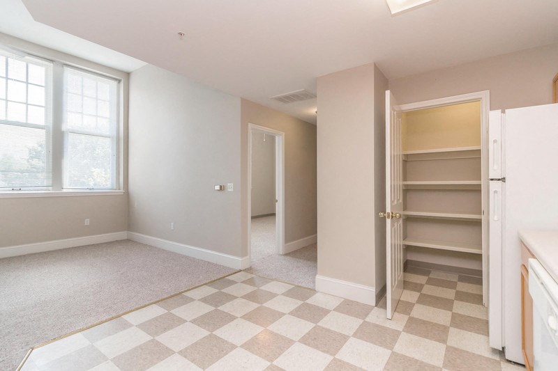 an empty room with a closet and a checkered floor