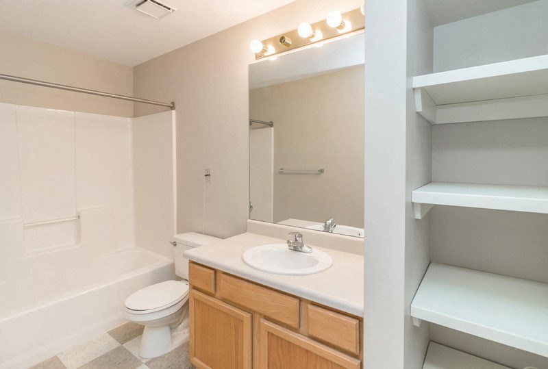 a bathroom with a sink toilet and a mirror