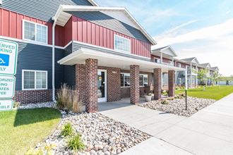 the front of a house with a sidewalk and landscaping