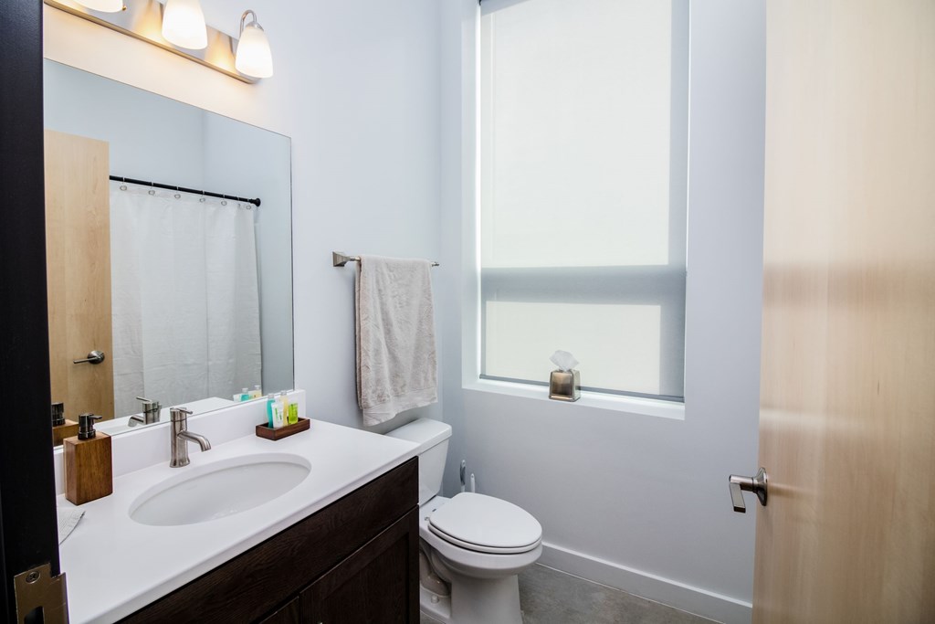 a small bathroom with a sink toilet and mirror