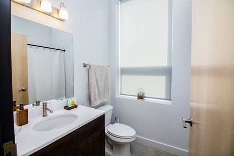 a small bathroom with a sink toilet and mirror