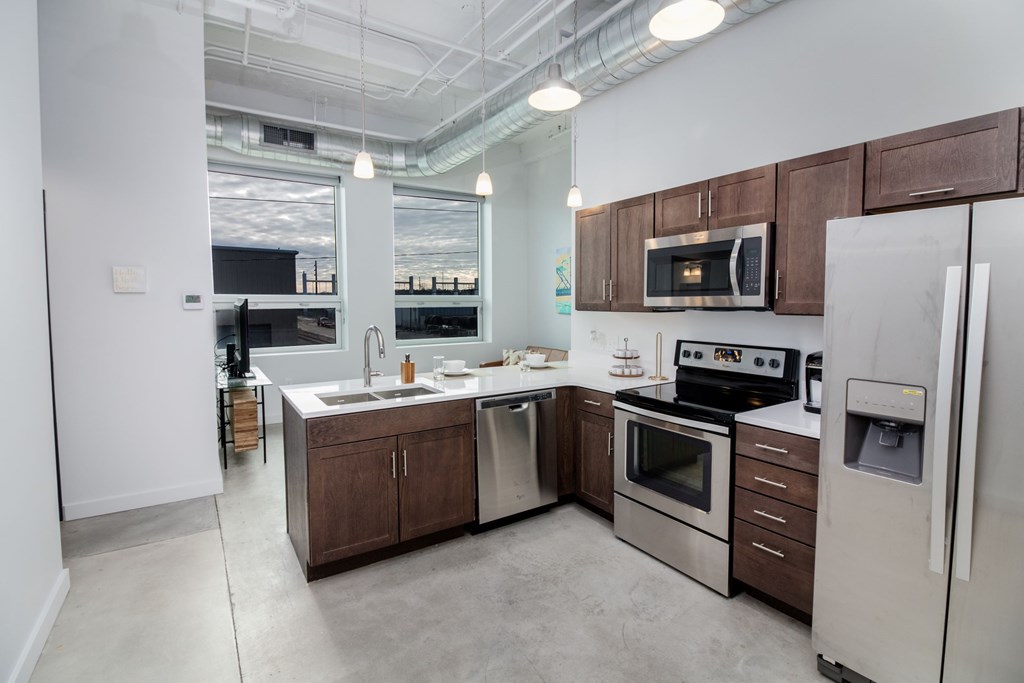 a kitchen with wooden cabinets and stainless steel appliances