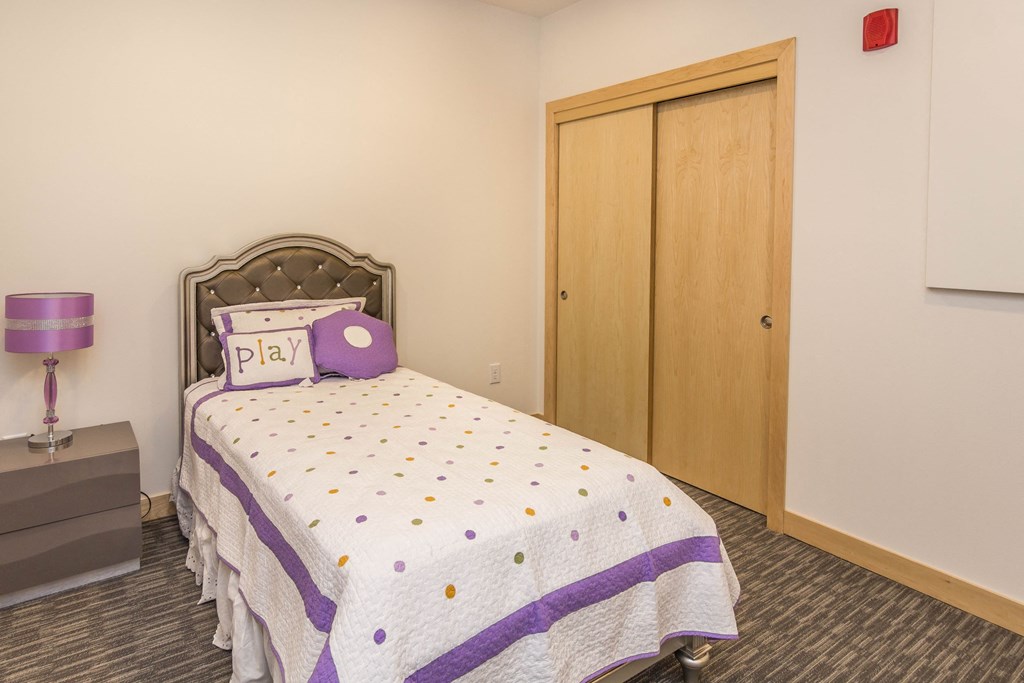 a bedroom with a bed and a closet