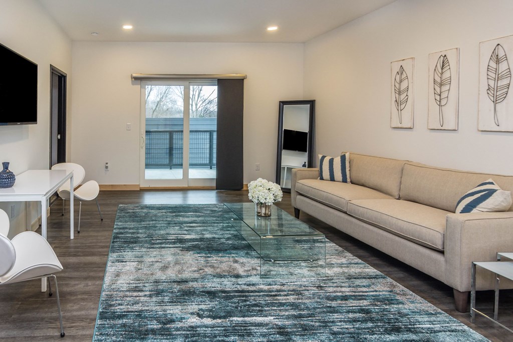 a living room with a couch and a glass coffee table