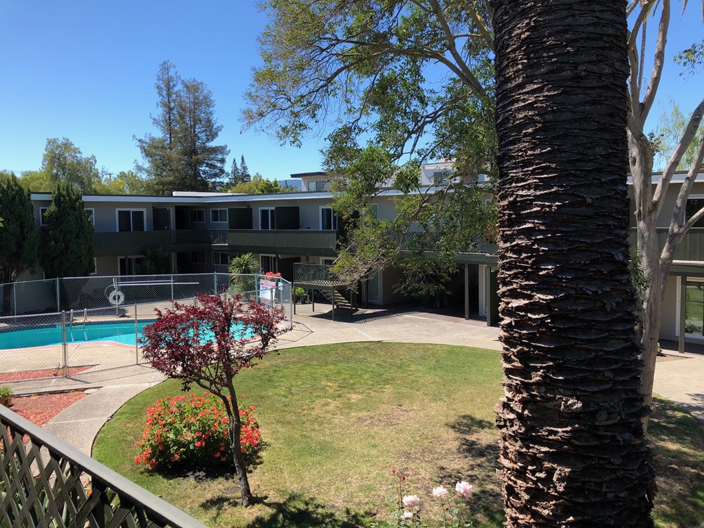the view of the pool from the balcony of a house