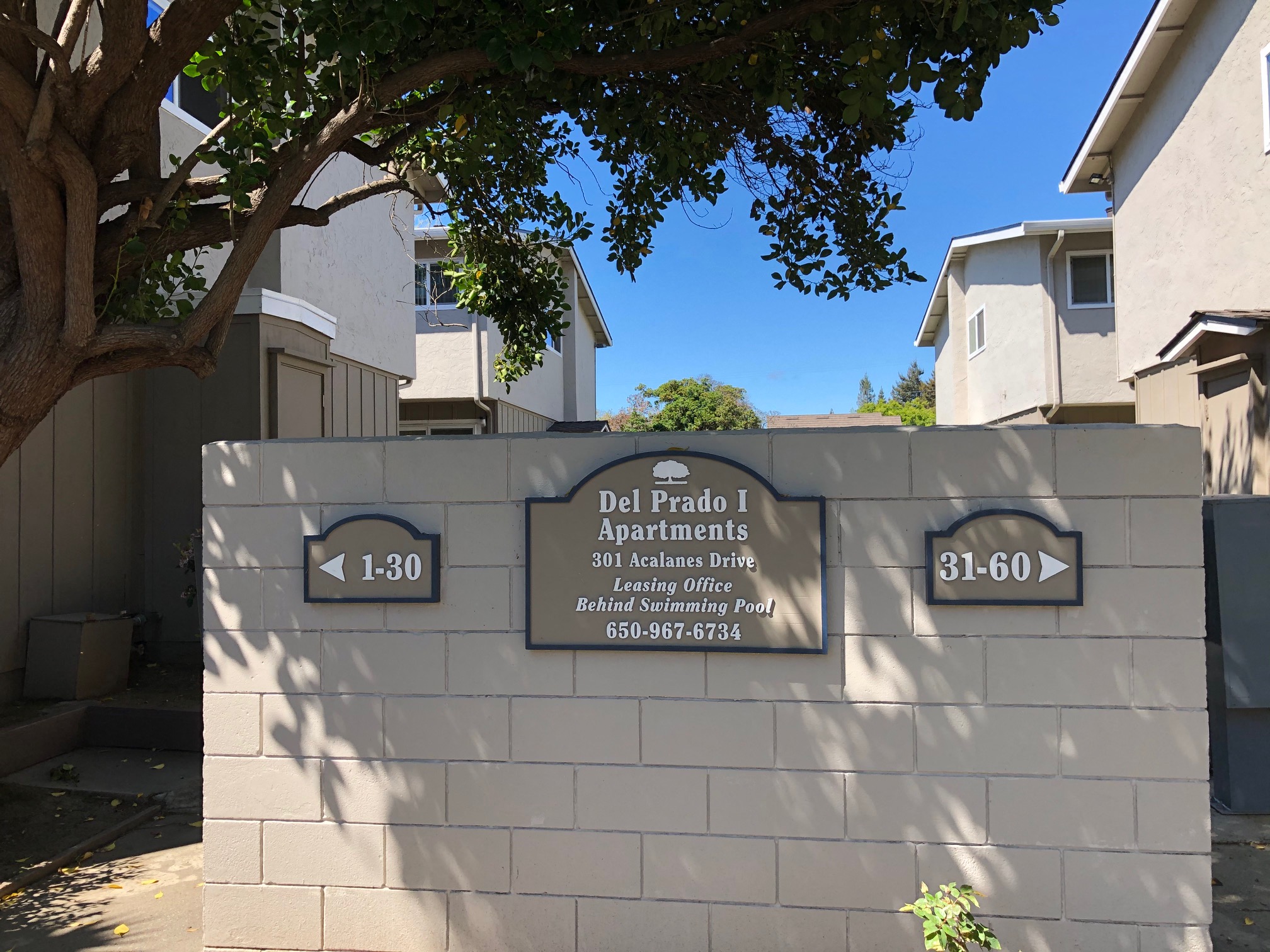 a wall with a sign on it in front of some apartments