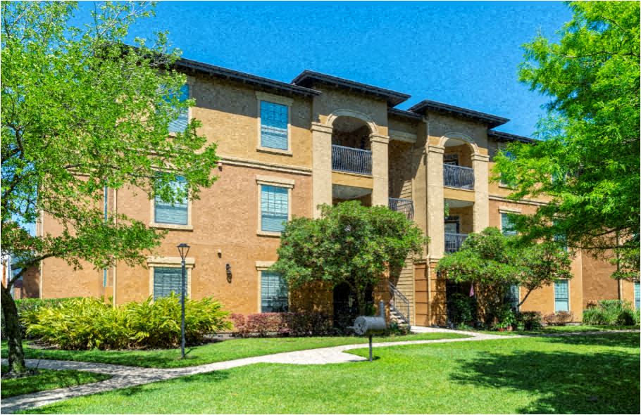 a large brick building with trees in front of it
