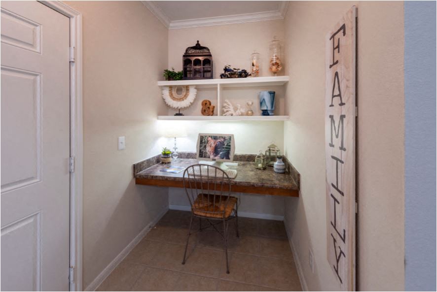 a home office with a desk and a chair