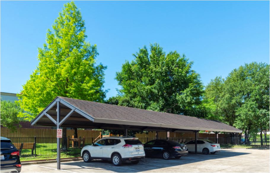 a parking lot with cars parked under a shelter