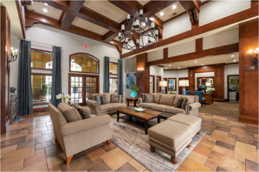 a large living room with couches and chairs and a chandelier