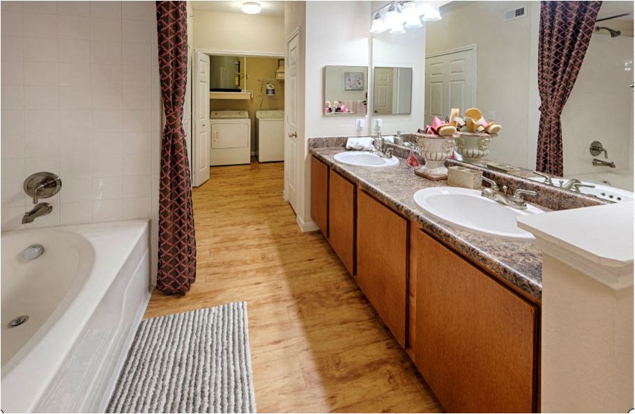 a bathroom with two sinks and a tub