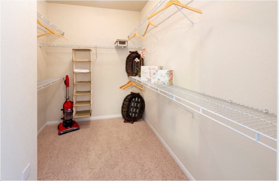 a walk in closet with shelves and a heater
