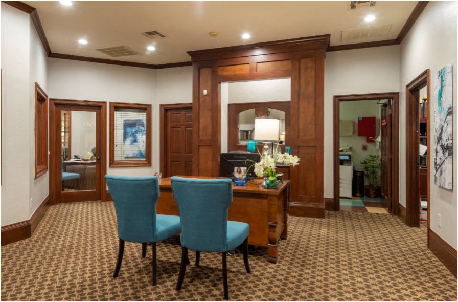 a dining room with a table and blue chairs