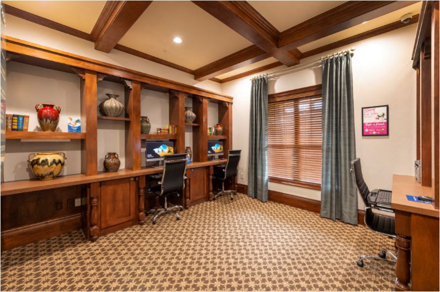 a home office with a desk and a window