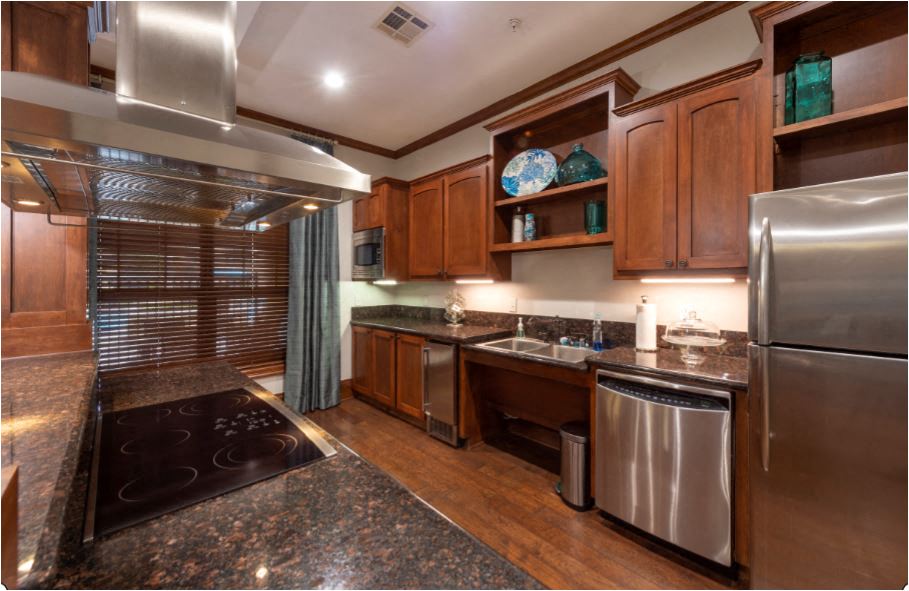 a kitchen with granite counter tops and stainless steel appliances