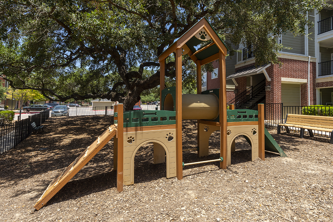a playground with a swing set and a slide
