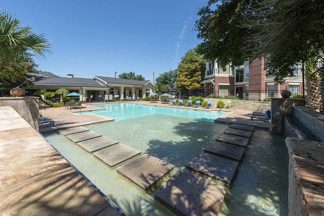 a swimming pool with a building in the background