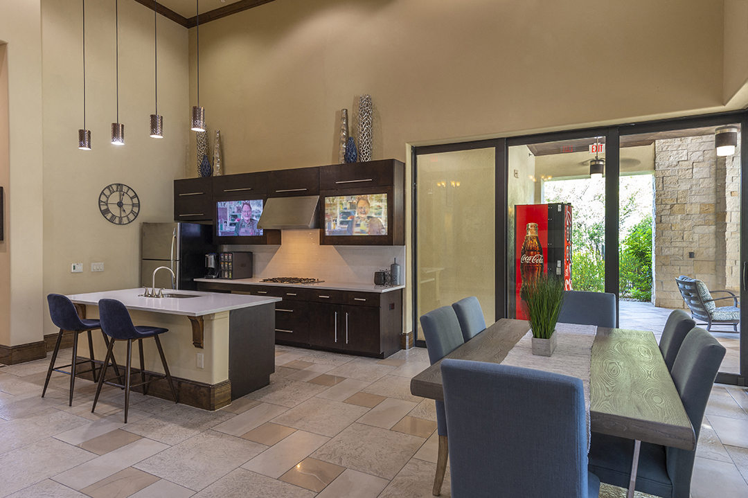 a kitchen and dining room with a table and chairs