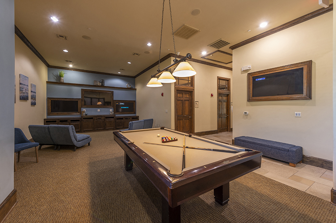 a game room with a pool table and a tv