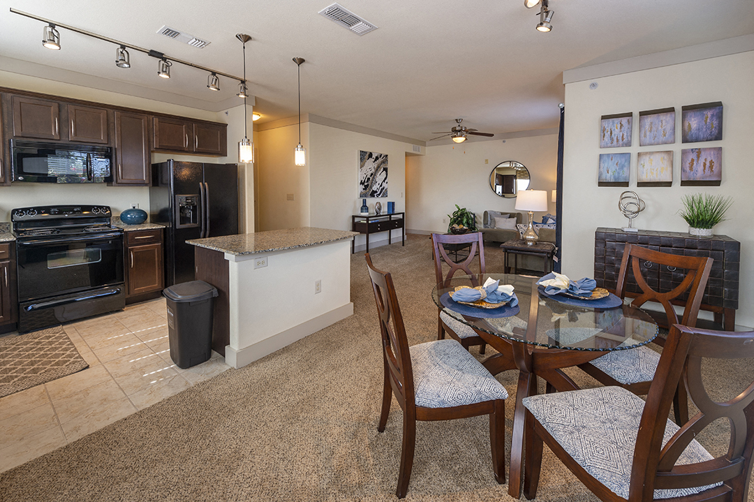a kitchen and dining room with a table and chairs