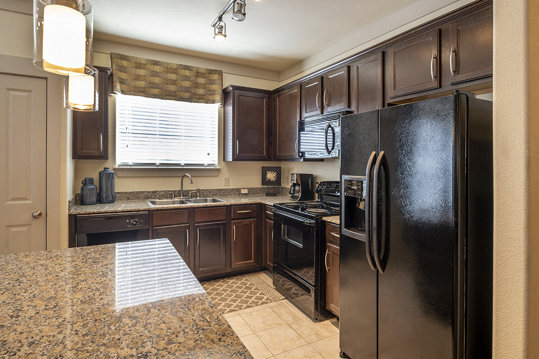 a kitchen with stainless steel appliances and granite counter tops