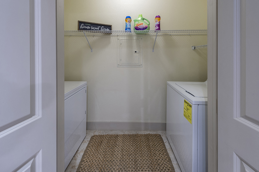 a small laundry room with two washes and a dryer